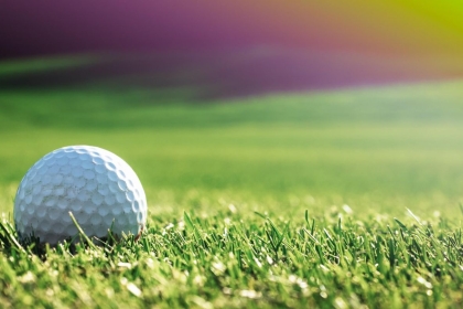 Golf Ball Pictured on Grass about to be Hit by Golf Club