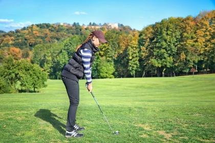 Lady Playing Golf on Sunny Golf Course